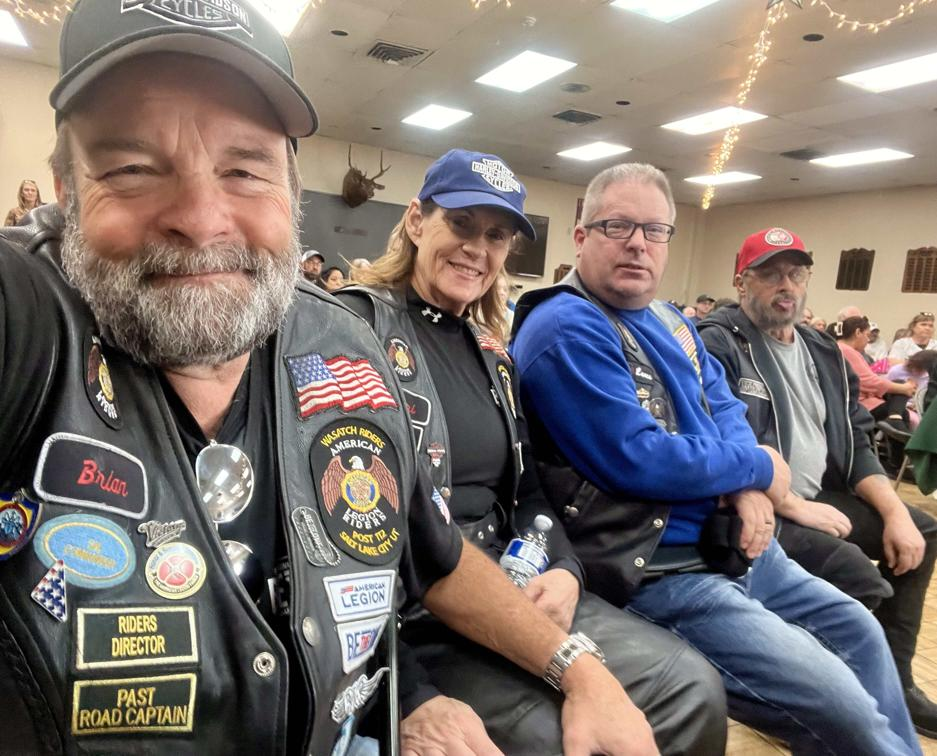 Four riders seated together at an indoor gathering