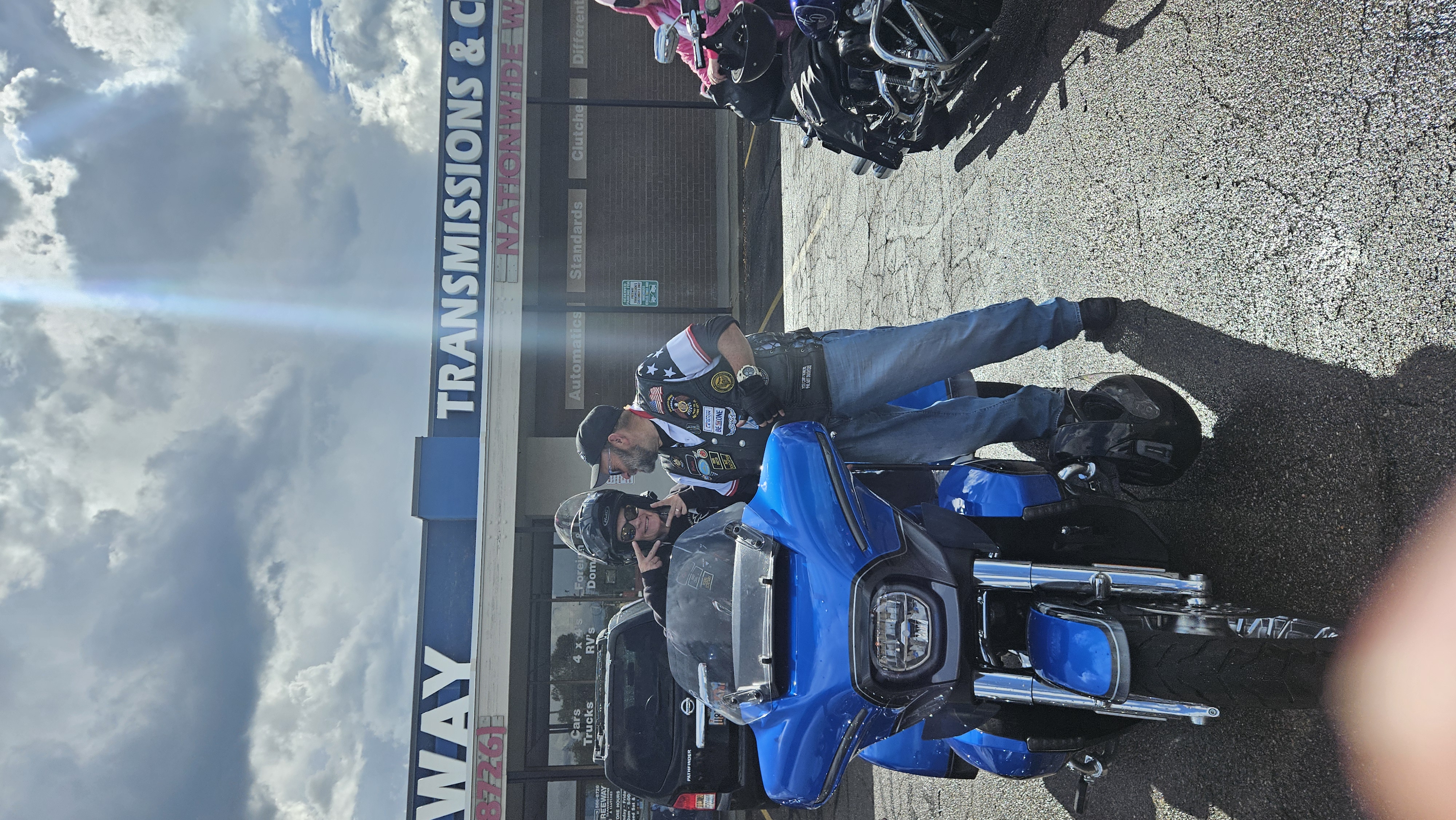Legion Riders beside a blue touring motorcycle